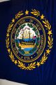 New Hampshire flag with state seal in Concord, New Hampshire, USA.