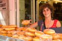 Woman selling beignets in the town of Saint-Jean-de-Luz, Pyrenees-Atlantiques, French Basque Country, Southwest France.