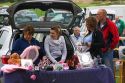 People buy and sell household items at a car boot sale in the market town of Banbury, Oxfordshire, England.