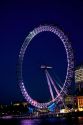 The London Eye at night along the River Thames in London, England.