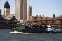 Tugboat guiding a garbage barge on the East River in New York City, New York, USA.
