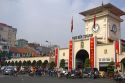 Vietnamese people ride motorbikes in front of the Ben Thanh Market in Ho Chi Minh City, Vietnam.