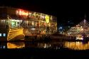 Floating restaurants on the Saigon River with lights at night in Ho Chi Minh City, Vietnam.