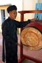 Monk sounding a drum at a temple in Hoi An, Vietnam.
