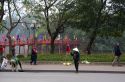 Street vendor in front of the Huc Bridge on Hoan Kiem Lake in Hanoi, Vietnam.