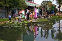 People walk across a small footbridge during Tet Lunar New Year celebrations in Ho Chi Minh City, Vietnam.
