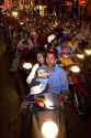 Vietnamese people ride motorbikes on Dong Khoi street during the last night of Tet Lunar New Year celebrations in Ho Chi Minh City, Vietnam.