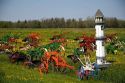 Colorfully painted antique plows on display at a farm near Corunna, Michigan, USA.