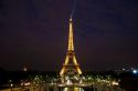 The Eiffel Tower lit up at night located on the Champ de Mars in Paris, France.