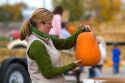 Woman shopping for pumpkins at a farmers market in Fruitland, Idaho. MR