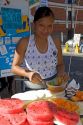 Street vendor carving and selling melon in the city of Puebla, Puebla, Mexico.
