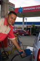 Attendant pumps fuel at a gas station in Limon, Costa Rica.