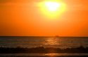 Fishing boat in the pacific ocean at sunset off the coast of Jaco, Costa Rica.