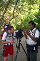 Tourist and nature guide look at wildlife through a telescope in the Manuel Antonio National Park in Puntarenas province, Costa Rica.