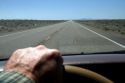 Drivers hand on the steering wheel of an automoble, Oregon, USA.
