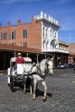 Tourists ride in a horse drawn carriage at Old Sacramento State Historic Park in Sacramento, Califorina, USA.