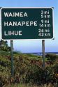 Road sign showing distance in kilometers and miles on the island of Kauai, Hawaii, USA.