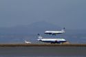 Airliners land and take off from San Francisco International Airport, California, USA.