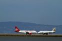 Airliners land and take off from San Francisco International Airport, California, USA.