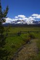 Split rail fencing and a fresh water creek running through a meadow near Stanley, Idaho, USA.