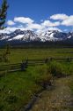 Split rail fencing and a fresh water creek running through a meadow near Stanley, Idaho, USA.