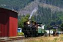 Tourists ride behind a 1910 Heisler Steam Locomotive at Garibaldi, Oregon, USA.