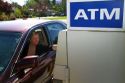Woman making a cash withdrawal from and ATM in Boise, Idaho, USA. MR