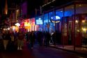 Neon signs of bars and restaurants along Bourbon Street in the French Quarter of New Orleans, Louisiana, USA.