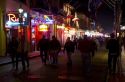 Neon signs of bars and restaurants along Bourbon Street in the French Quarter of New Orleans, Louisiana, USA.