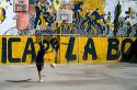 Argentine boy playing soccer in the La Boca barrio of Buenos Aires, Argentina.