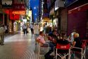 People walking on Lavalle Street at night in Buenos Aires, Argentina.