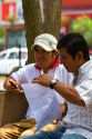 Men having a meeting in Central Park of the Miraflores district of Lima, Peru.