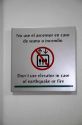 Warning sign for elevator in case of earthquake in spanish and english languages at Lima, Peru.
