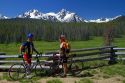 Touring bicyclists stop for a view of the Sawtooth Mountain Range near Stanley, Idaho, USA.