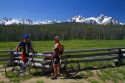 Touring bicyclists stop for a view of the Sawtooth Mountain Range near Stanley, Idaho, USA.