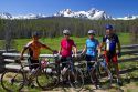 Touring bicyclists stop for a view of the Sawtooth Mountain Range near Stanley, Idaho, USA.