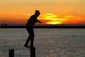 People watch the sunset on Lake Michigan at Pere Marquette Harbor located in Ludington, Michigan, USA.