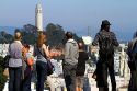 Tourists view Coit Tower located on Telegraph Hill in San Francisco, California, USA.