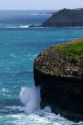 Pacific ocean waves crash against the lava peninsula of Kilauea Point National Wildlife Refuge on the island of Kauai, Hawaii, USA.