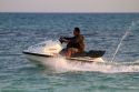 Man riding a personal water craft in the Gulf of Thailand at Chaweng beach on the island of Ko Samui, Thailand.