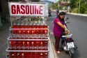 Gasoline being sold in one liter whiskey bottles at Chaweng beach village on the island of Ko Samui, Thailand.