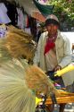 Street vendors selling dried grass brooms on the island of Ko Samui, Thailand.
