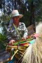 Street vendors selling dried grass brooms on the island of Ko Samui, Thailand.