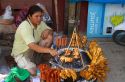 Food vendor grilling meat over a charcoal fire at Chaweng beach on the island of Ko Samui, Thailand.