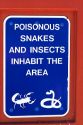 Sign warning of poisonous snakes and insects at a rest area along Interstate 10 in southern Arizona, USA.