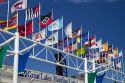 Shipping company flags in front of the Great Lakes Maritime Center along the St. Clair river where it meets the Black River at Port Huron, Michigan, USA.