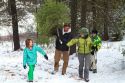 Family cutting a christmas tree in the Boise National Forest near Idaho City, Idaho, USA.