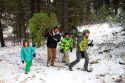Family cutting a christmas tree in the Boise National Forest near Idaho City, Idaho, USA.