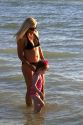 Mother and daughter holding hands at the beach on the coast of Florida, USA.