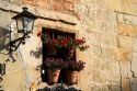 Flower pots in the window of a building in the village of Santillana del Mar, Cantabria, Spain.